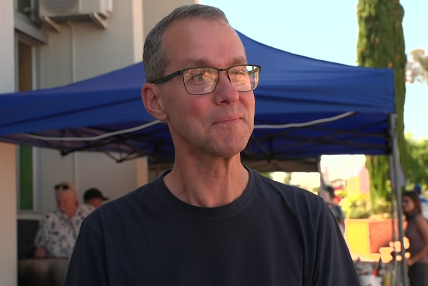 A man wearing a black T-shirt