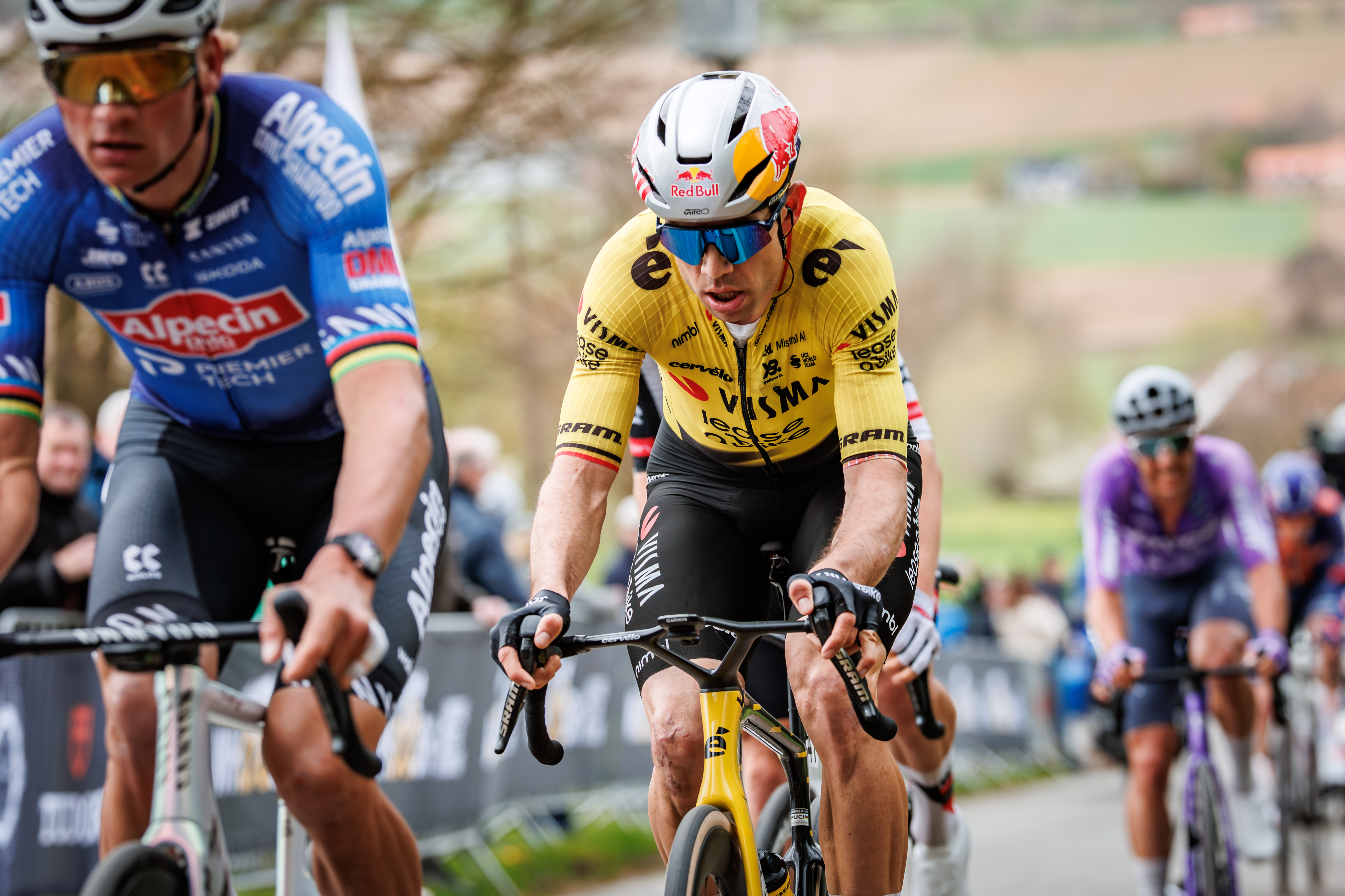 Van der Poel (L) and Van Aert (center) ride away from the field