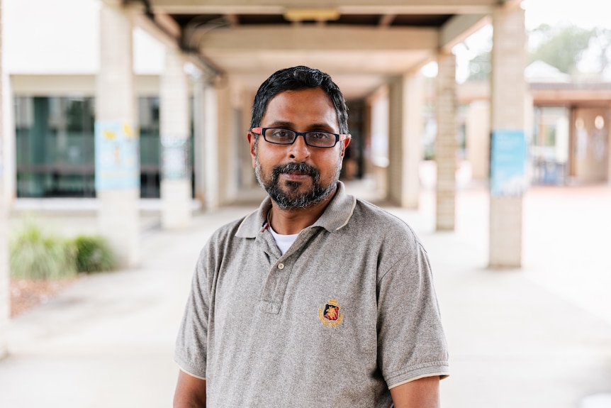 A medium shot of a man in button up shirt