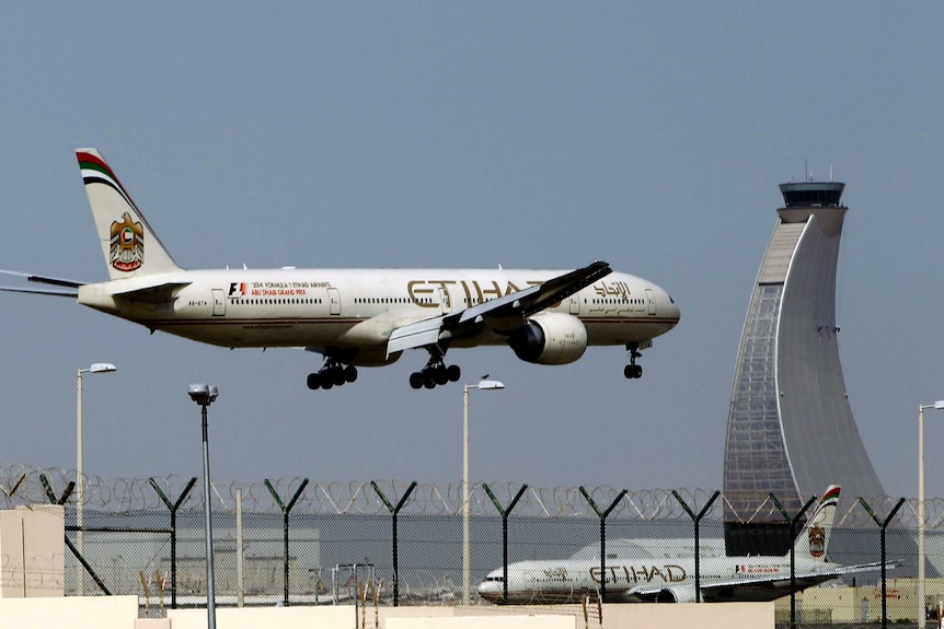 A large plane comes in to land at an airport.