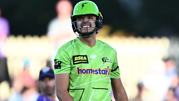 HOBART, AUSTRALIA - DECEMBER 16: Sam Konstas of the Thunder reacts after he is struck by a delivery during the BBL match between Hobart Hurricanes and Sydney Thunder at Ninja Stadium, on December 16, 2025, in Hobart, Australia (Photo by Steve Bell/Getty Images)