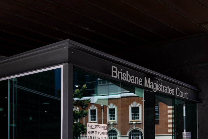 Signs and markers pointing to Brisbane's Magistrates Court