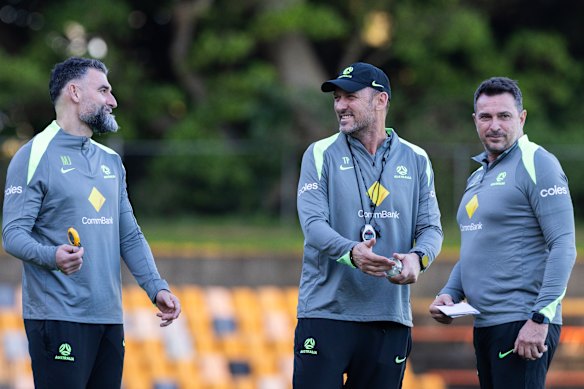 Tony Popovic with Mile Jedinak and Paul Okon, his assistant coaches, at Socceroos training in Sydney on Tuesday.
