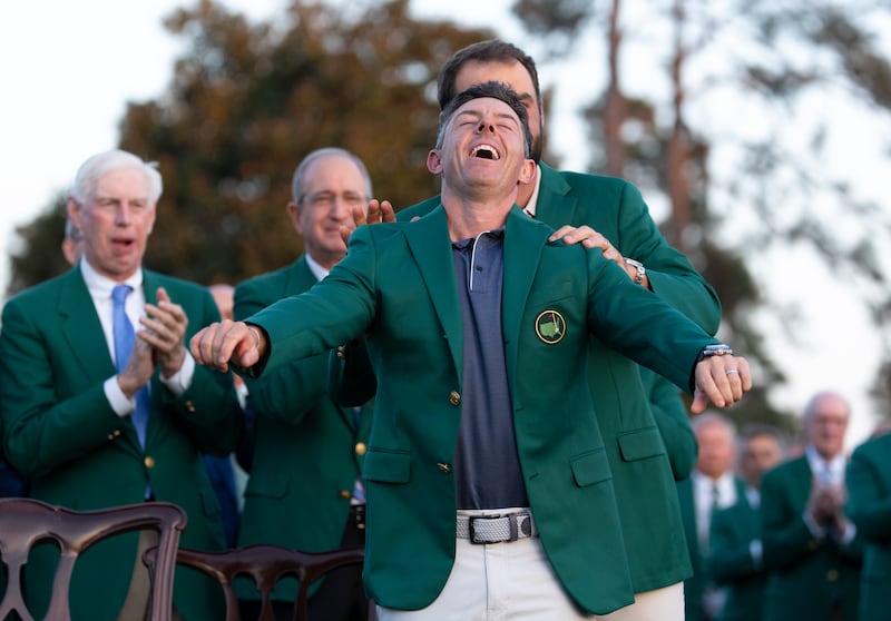 Rory McIlroy receives his green jacket from Scottie Scheffler after winning the 2025 Masters at August National. Photograph: Simon Bruty/Augusta National/Getty Images