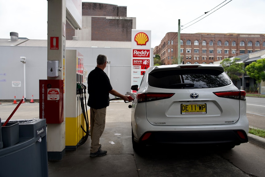A man fuelling up his car at Shell service station.