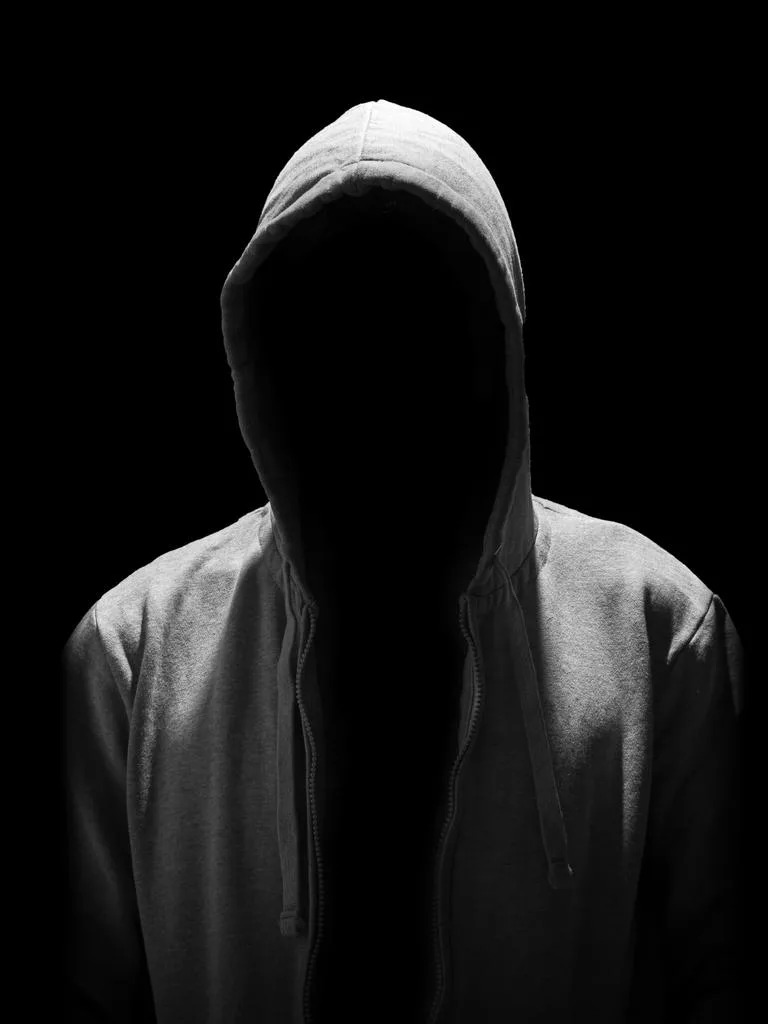 Portrait of Invisible man in the hood isolated on black