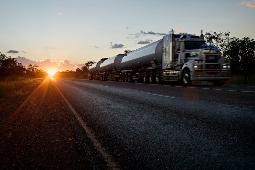 A roadtrain and a setting sun.