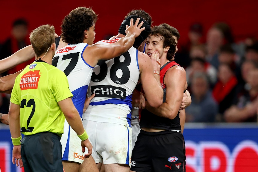 Tristan Xerri rubs blood on the face of Andrew McGrath