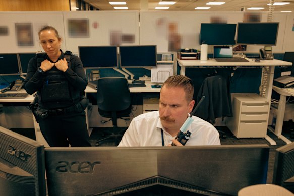  Detective Senior Sergeant Stacey Dwyer and Acting Detective Sergeant Maxwell Slarke watching the AirWing feed at Sunshine police station.