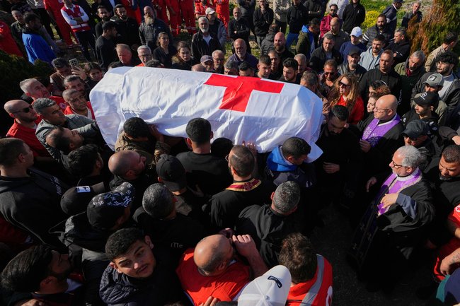 Mourners carry the coffin of Youssef Assaf, a Lebanese Red Cross volunteer who was killed in an Israeli airstrike.