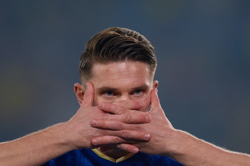 Sweden player Viktor Gyökeres has his hands intertwined and covering his mouth, only showing his eyes