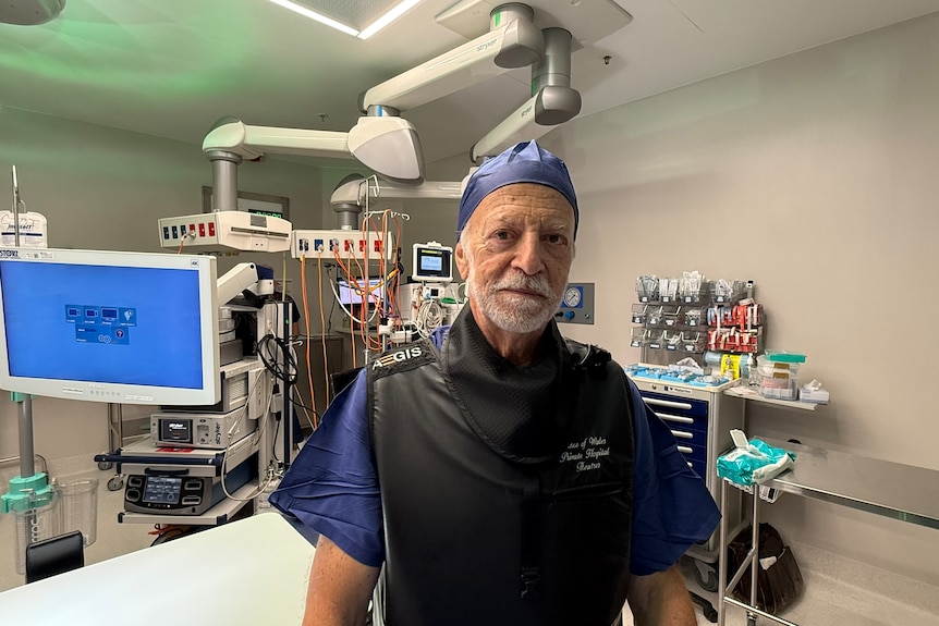 Professor Thierry Vancaillie stands inside a hospital theatre room.