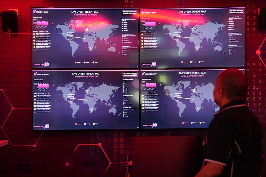 Monitors displaying global cyber threats
