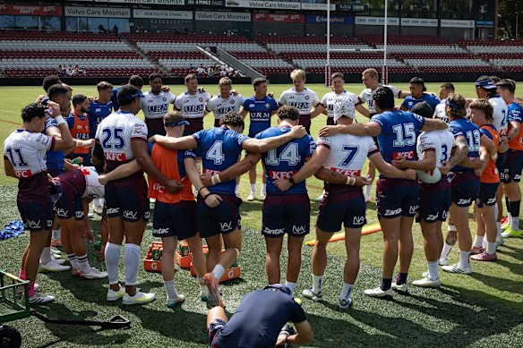 Huddle up: Manly players bring it in at training on Monday.