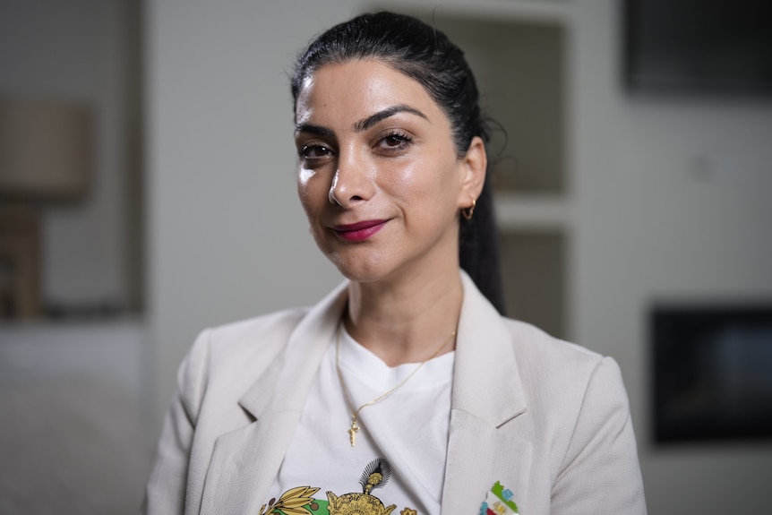 Woman with black hair looking at camera