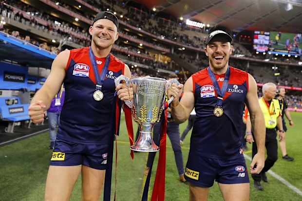 PERTH, AUSTRALIA - SEPTEMBER 25: Steven May of the Demons and Michael Hibberd of the Demons celebrate with the premiership cup during the 2021 Toyota AFL Grand Final match between the Melbourne Demons and the Western Bulldogs at Optus Stadium on September 25, 2021 in Perth, Australia. (Photo by Dylan Burns/AFL Photos)