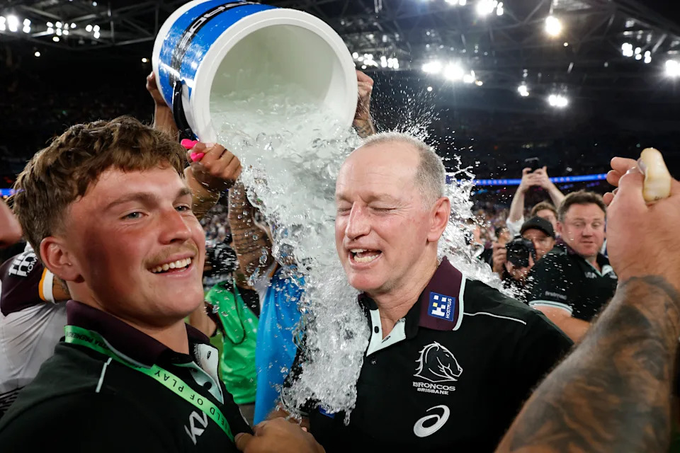 Seen here, Brisbane Broncos coach Michael Maguire celebrates with his players after their NRL grand final victory over Melbourne in 2025.