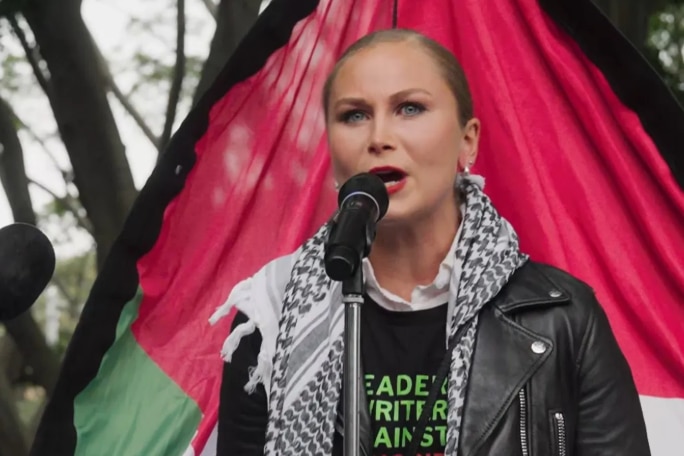 A woman speaking into the mic