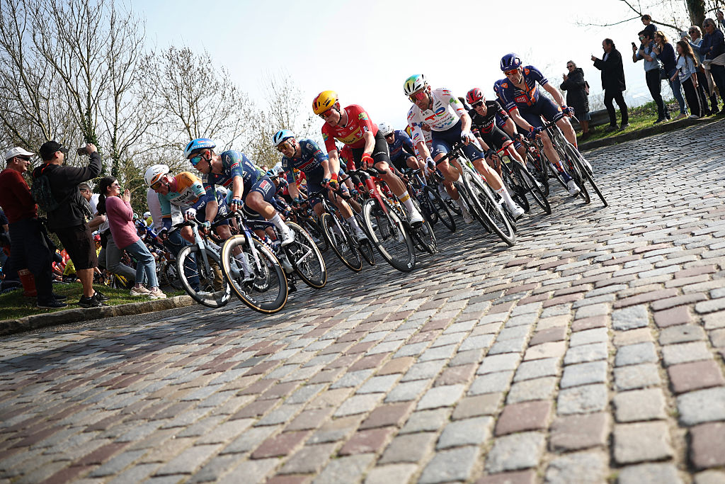 The pack climbs during the 1st stage of the Paris-Nice cycling race, 170.9 km between Ach&egrave;res and Carri&egrave;res-sous-Poissy, on March 8, 2026. (Photo by Anne-Christine POUJOULAT / AFP)