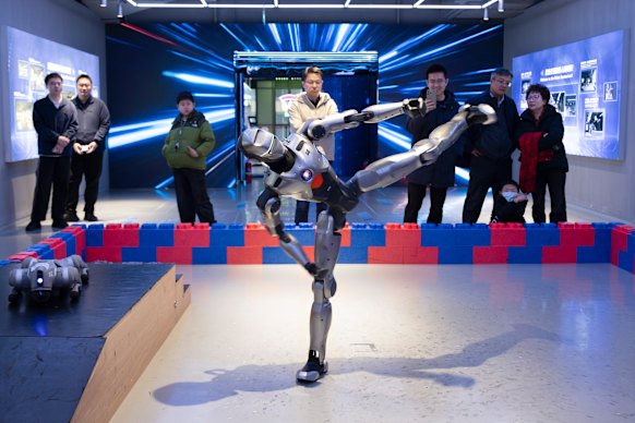A humanoid robot performs a kung fu  kick at the Robot Mall in Beijing.