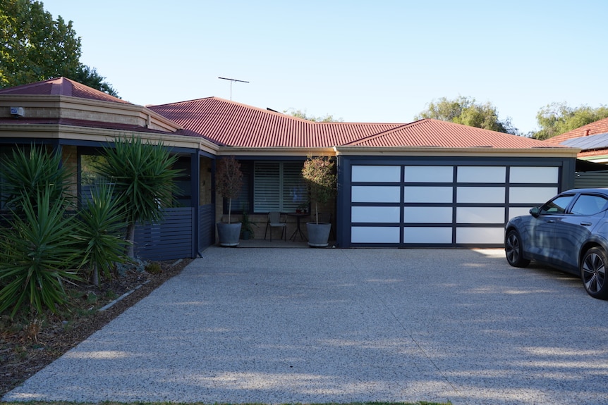 A home with a car parked out the front.
