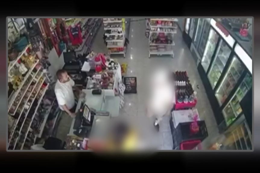 Image from above of one blurred figure in middle of frame and another blurred fugure at bottom