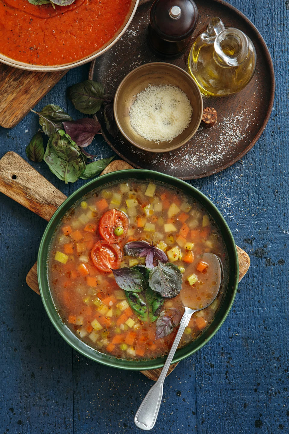 Vegan minestrone soup on dark blue background. Top view.