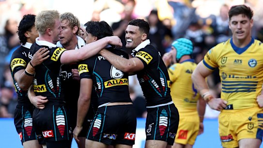 Penrith celebrate one of many tries against the Eels on Saturday.