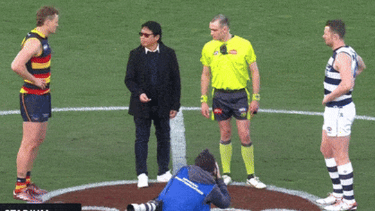 Sy Giang Nguyen tosses the coin before a Geelong-Adelaide AFL game in August.