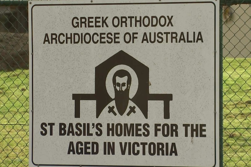A sign for the St Basil's Greek Orthodox aged care home in Fawkner, attached to a wire fence.
