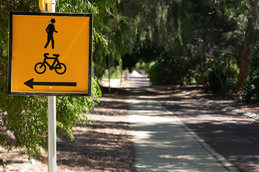 A yellow sign indicating the presence of pedestrians and cyclists