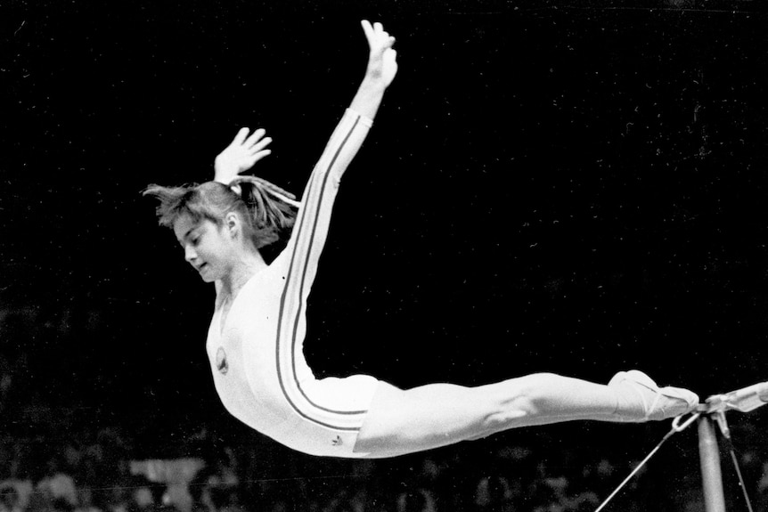 Nadia Comaneci dismounts from the uneven parallel bars