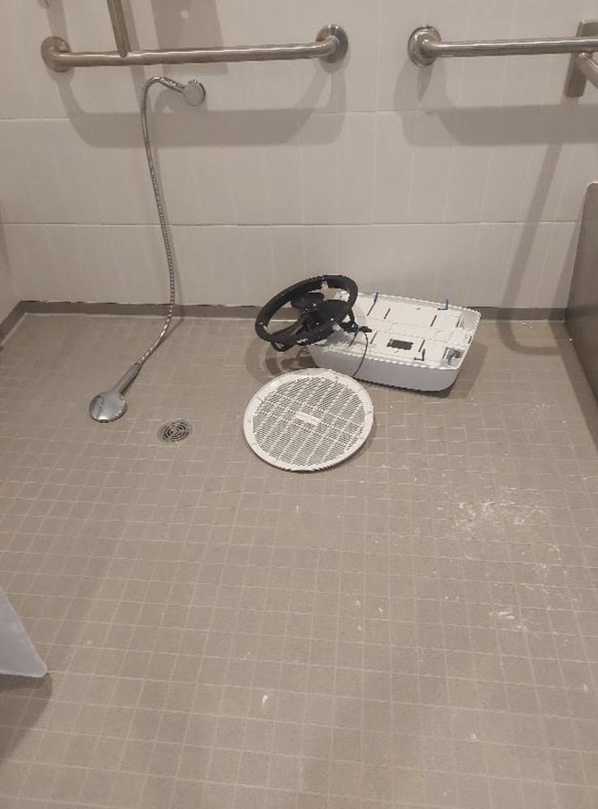 The exhaust fan and hand towel dispenser was ripped from the wall and the roof.