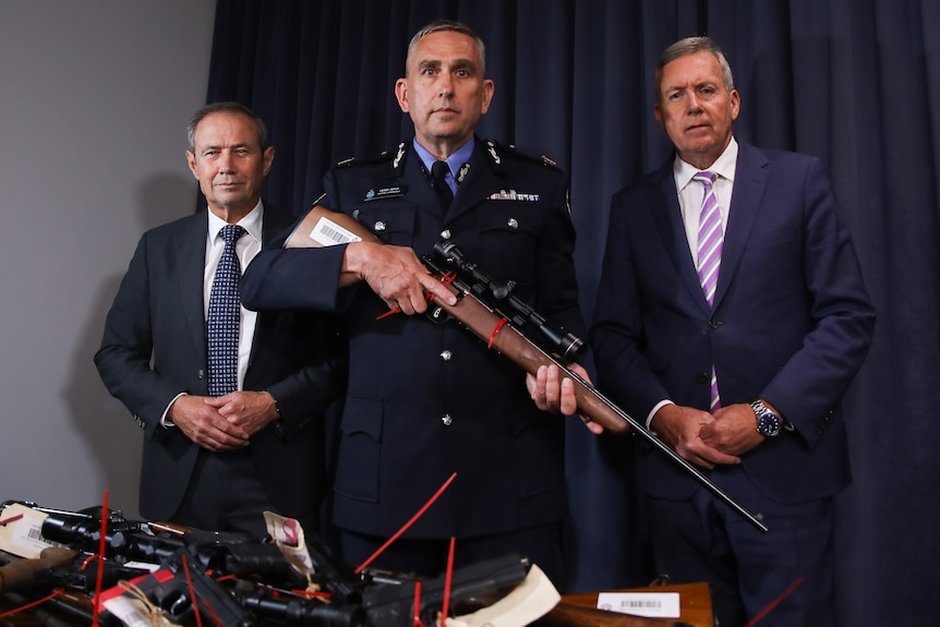 Premier Roger Cook, WA Police Assistant Commissioner and Police Minister Reece Whitby stand with guns