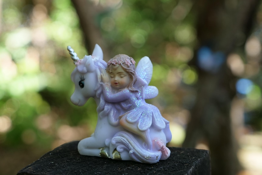 A little fairy statues of a fairy asleep on a unicorn