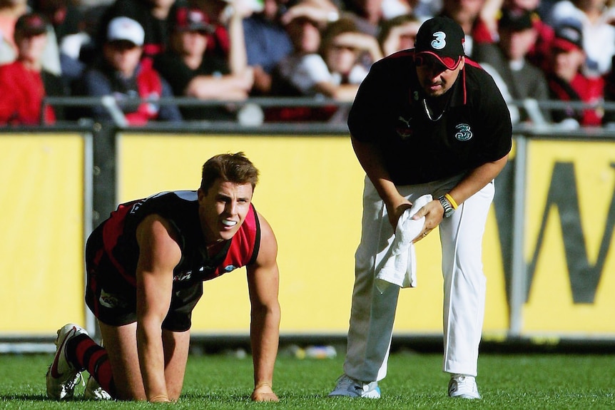 Matthew Lloyd on his hands and knees after tearing hamstring