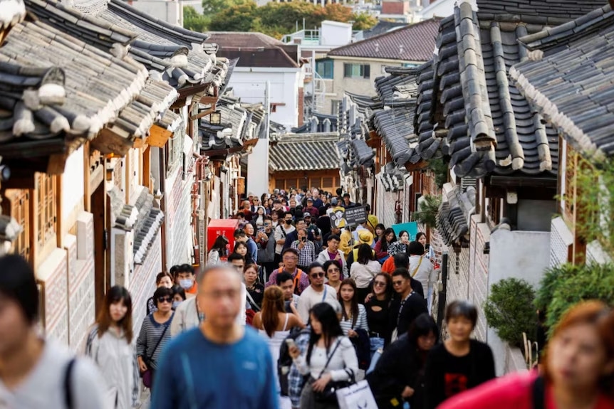 A crowd walking in a housing area.