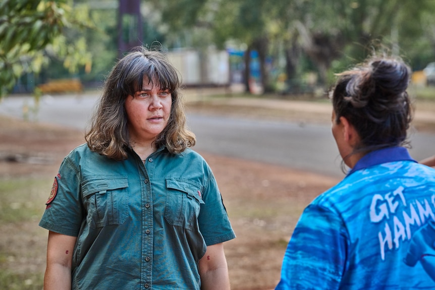A TV still of Shari Sebbens, 40, an Indigenous woman in a ranger's uniform, looking upset as she speaks to Madeleine Sami.