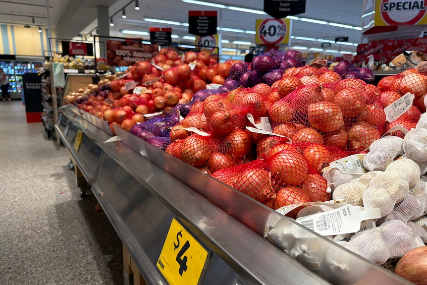 A display of onions in a supermarket.