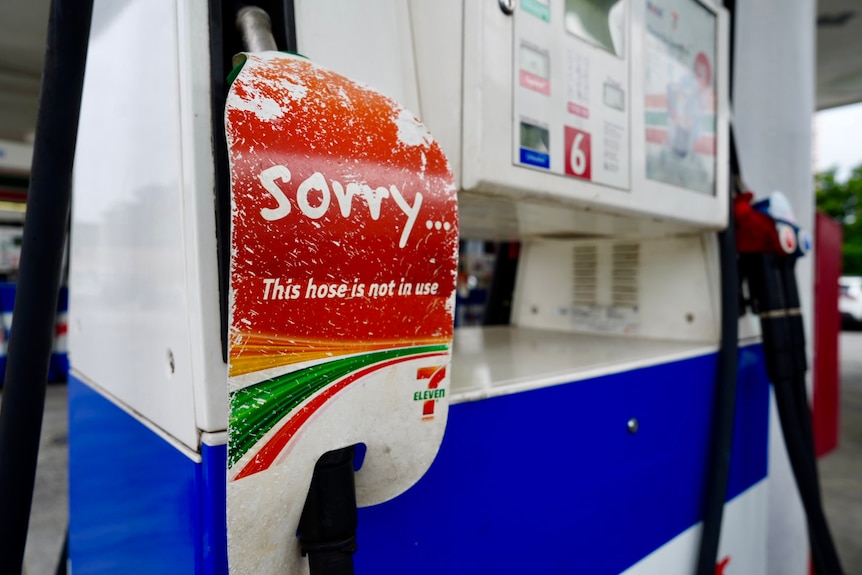 External shots of a 7/11 petrol station and fuel pump with an out of order sign.