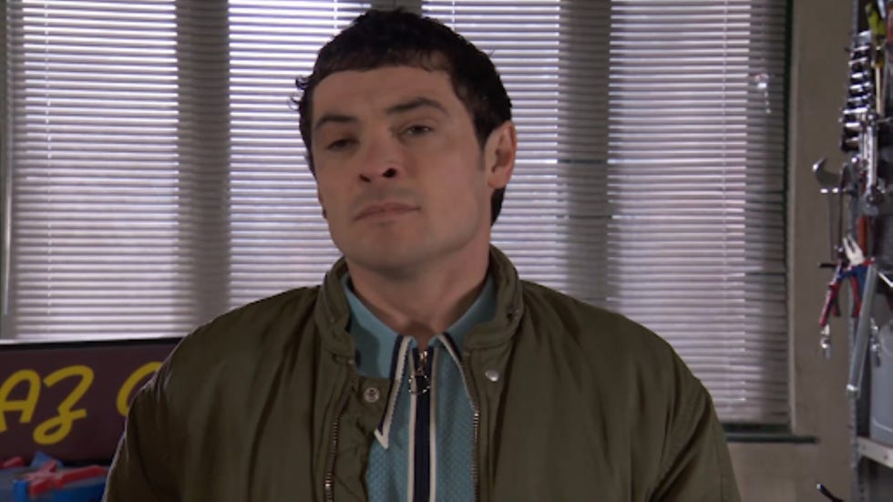 a person standing indoors partially obscured