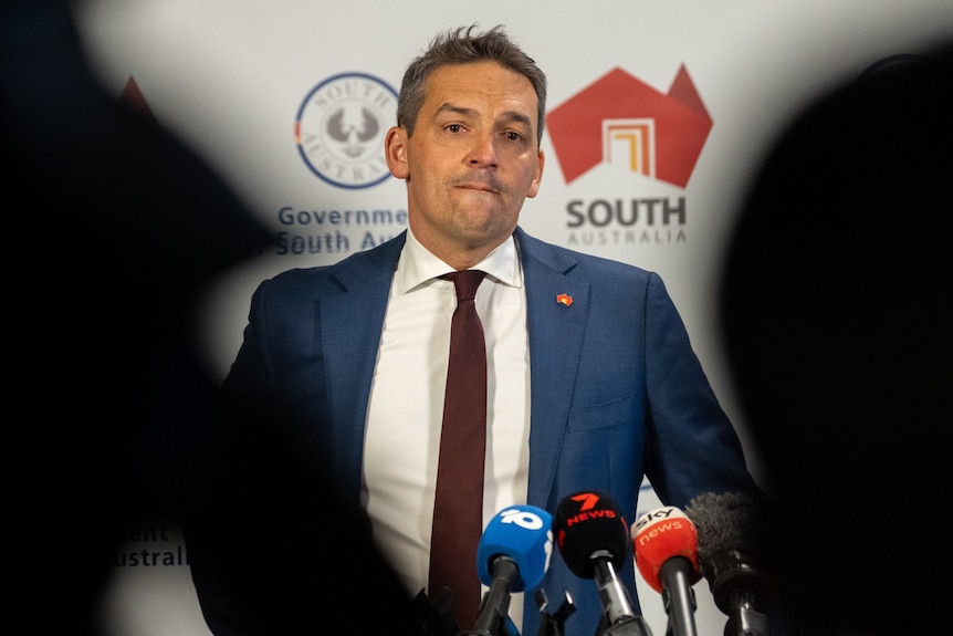 a man looks concerned at a press conference