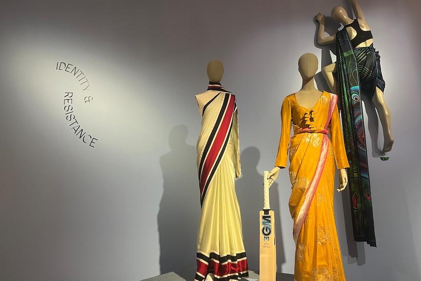 Three mannequins with saris on display