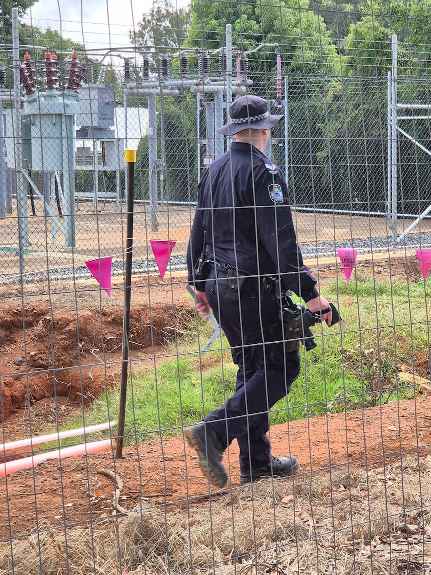 police officer behind fence