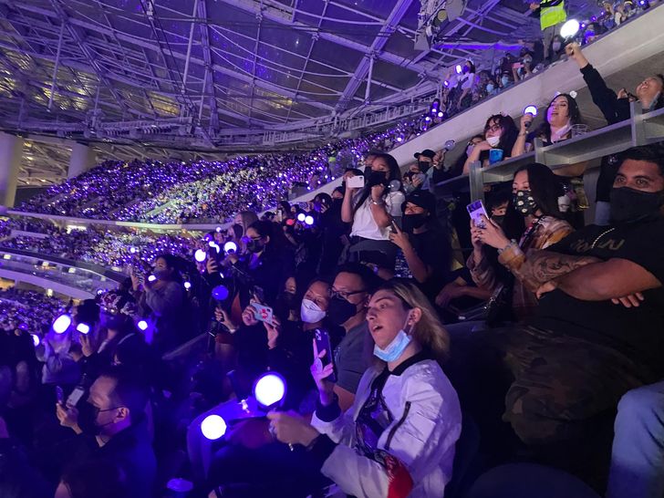 People take photos of K-pop group BTS during the boy band's first non-virtual concert since 2019 at SoFi Stadium in Los Angeles, Nov. 27, 2021. Yonhap