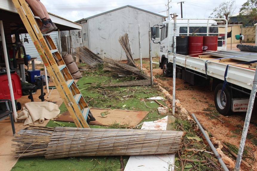 The fences around houses have fallen off the ground, along with tree twigs. 