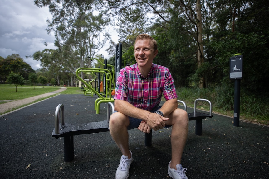 a man sits at a playground