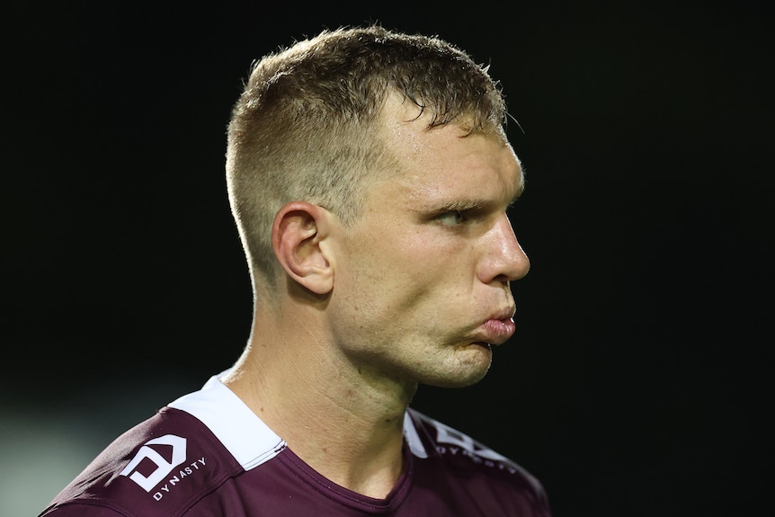 Tom Trbojevic of the Sea Eagles looks on, biting down on his mouth guard