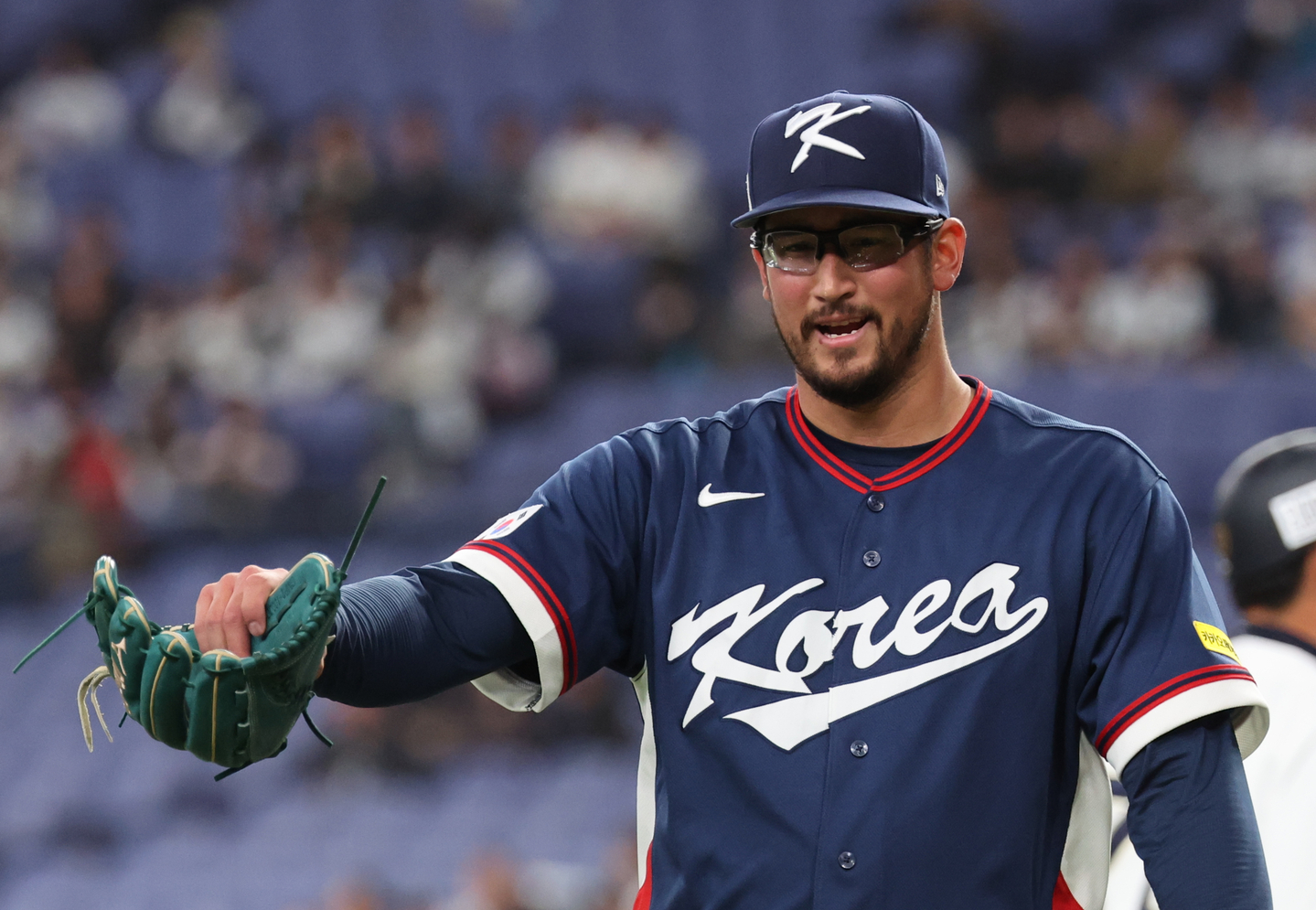 Korea starter Dane Dunning smiles after retiring the side in the bottom of the third inning of an exhibition game before the World Baseball Classic against the Orix Buffaloes at Kyocera Dome in Osaka on March 3. [YONHAP]