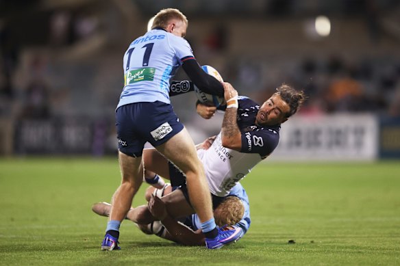 Max Jorgensen and Jamie Adamson tackle Andy Muirhead at GIO Stadium.